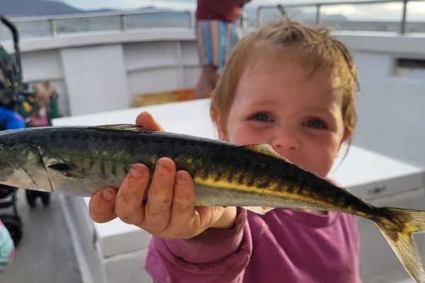 Angling_03 young kid holding up caught fish