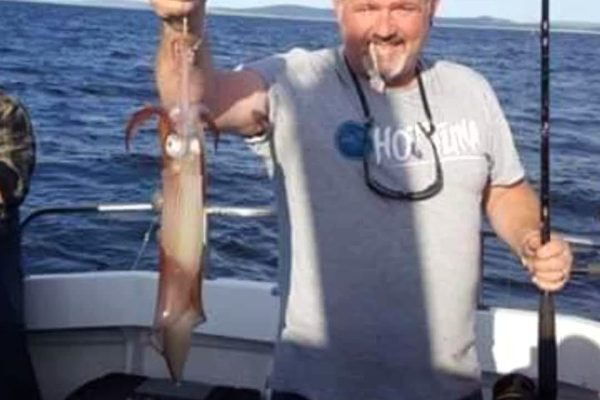 Angling_07 man holding up fish that he caught